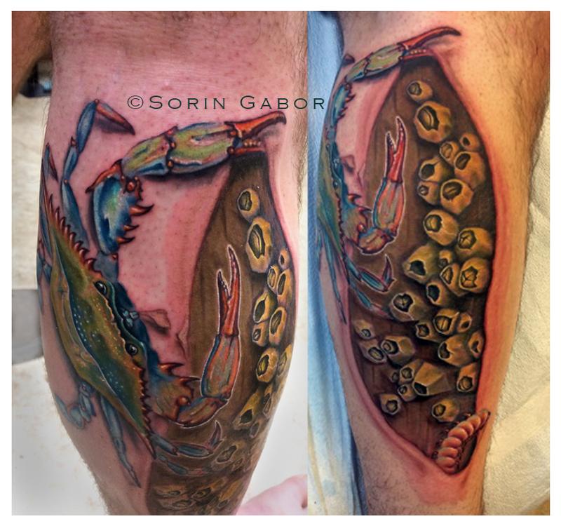 Realistic blue crab tattoo on leg with barnacles on dock and skin rip